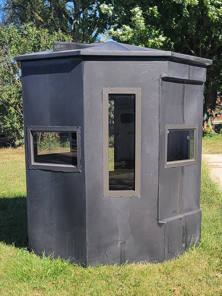 Hunting blind with vertical bow window and horizontal hinge windows