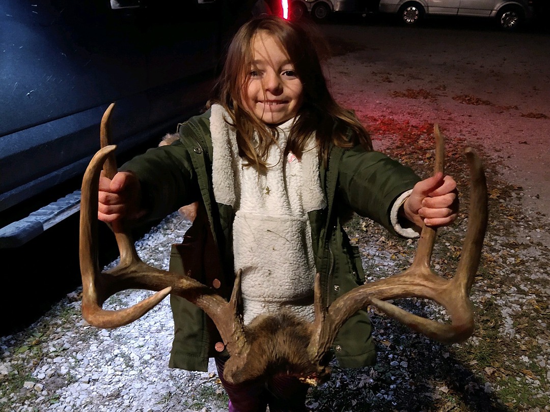 Girl holding antlers